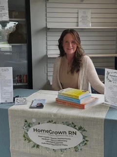 Chiropractic Norwood MA Suzanne Balestino Sitting At A Table Registered Nurse